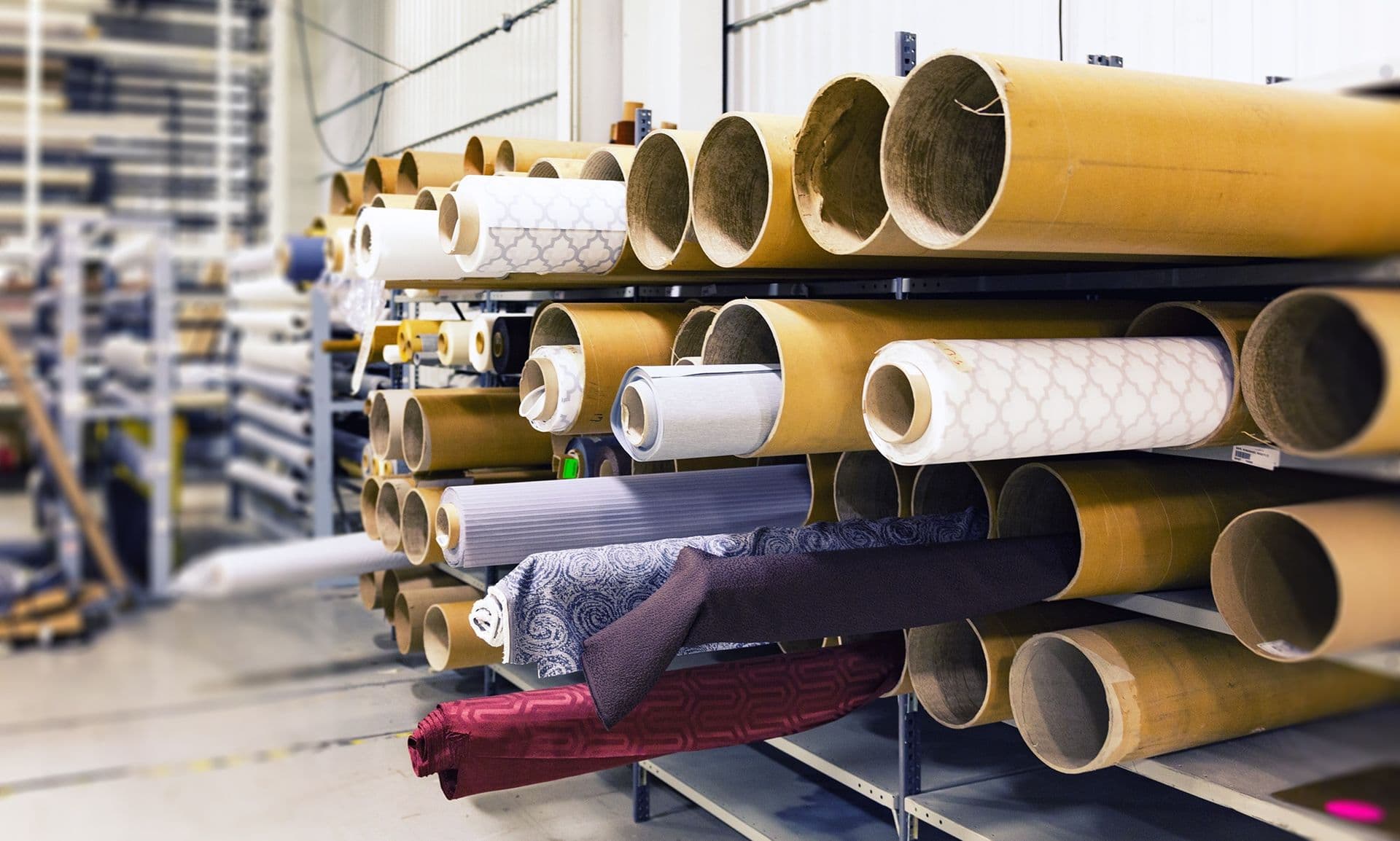 Rolls of fabric stored on warehouse racking