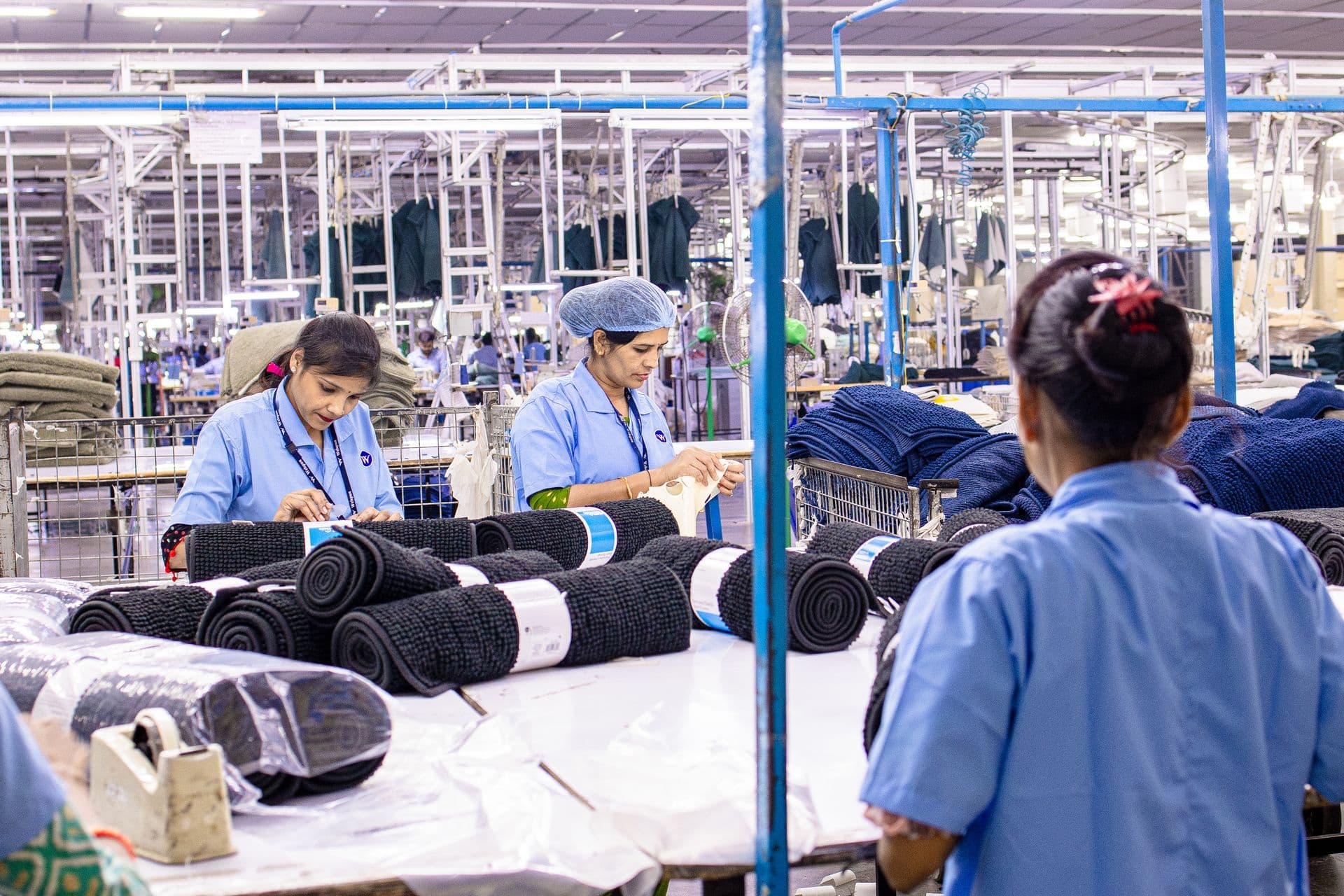 Workers on a busy garment production floor