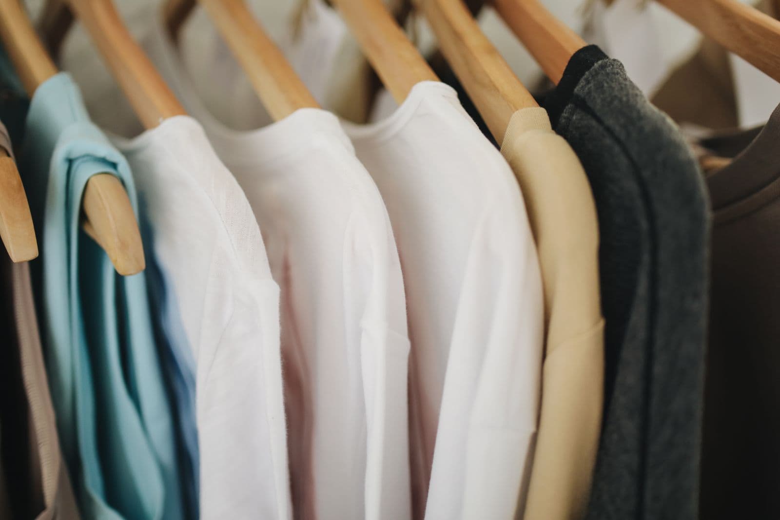 Neatly hung finished garments on wooden hangers