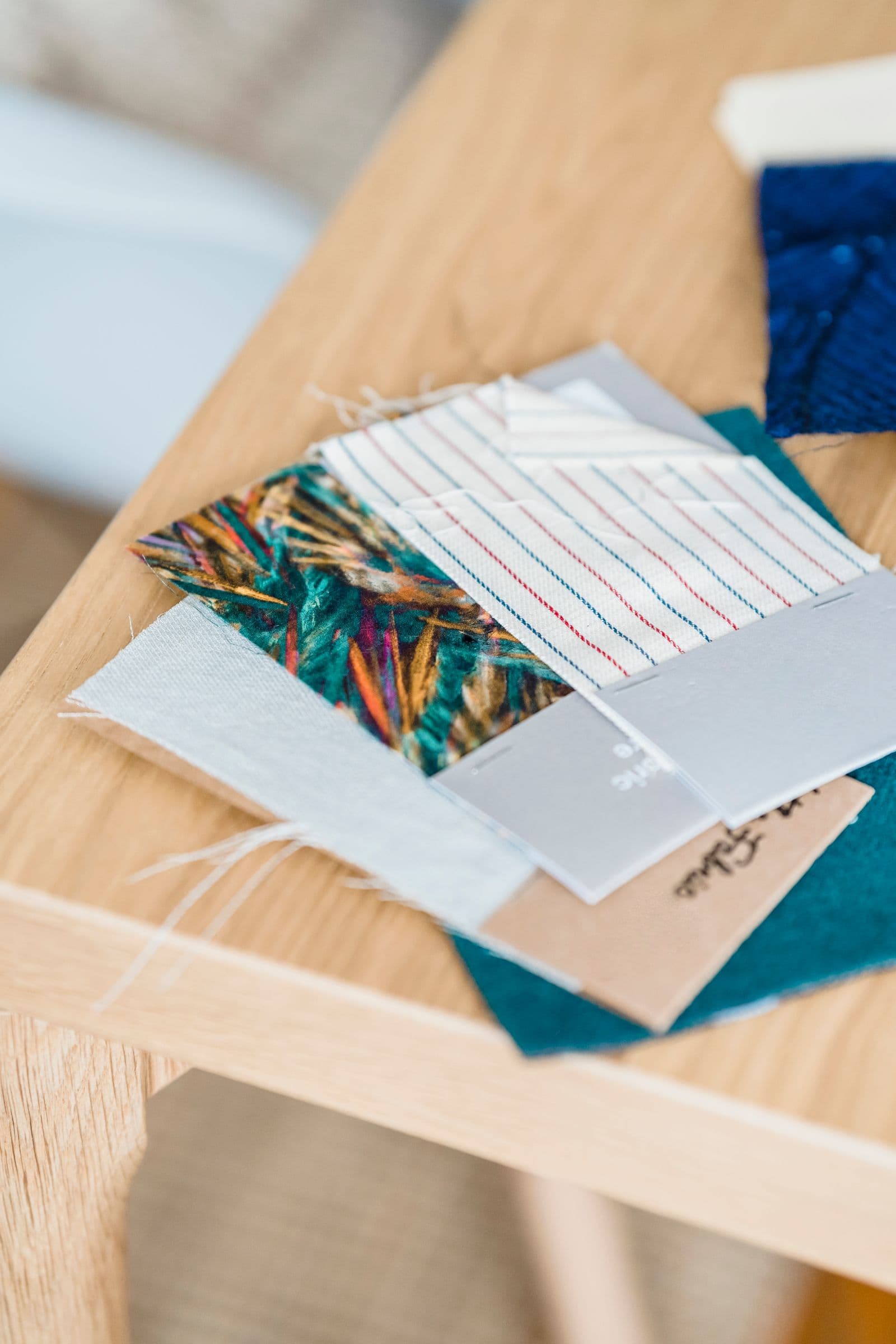 Fabric swatches and material samples on a development table